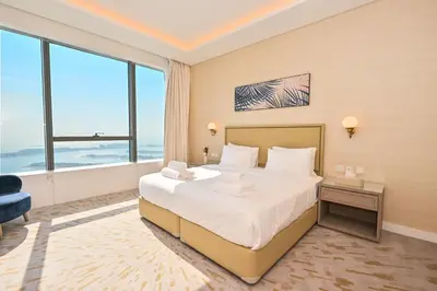 a bedroom with a large bed and a large window at Luxury 1-BR with Stunning Views in Palm Tower by Luxe Shortlet in Dubai