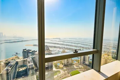 a view of the city from a window in a skyscraper at Luxury 1-BR with Stunning Views in Palm Tower by Luxe Shortlet in Dubai