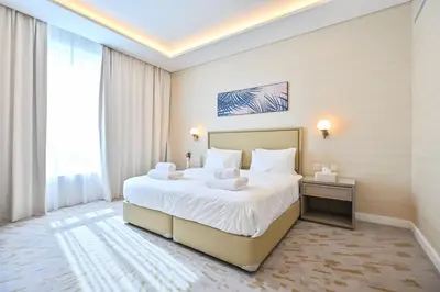 a bedroom with a large bed and a large window at Luxury 1-BR with Stunning Views in Palm Tower by Luxe Shortlet in Dubai