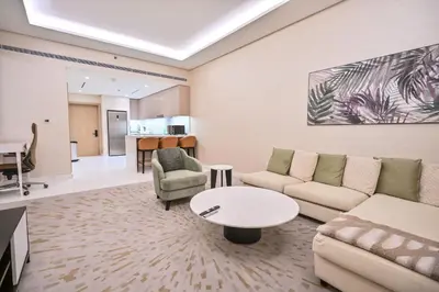 a living room with a couch and a table at Luxury 1-BR with Stunning Views in Palm Tower by Luxe Shortlet in Dubai