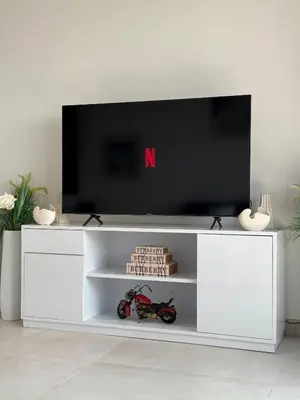 a white entertainment center with a flat screen tv at Jumeirah Heights in Dubai