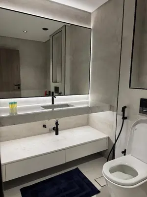 a bathroom with a toilet and a sink and a mirror at Jumeirah Heights in Dubai