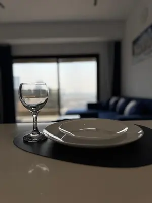 a plate and a wine glass sitting on a table at Jumeirah Heights in Dubai