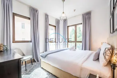 a bedroom with a bed and a desk and windows at Appealing 1BR Apartment at Miska 2 Old Town, Downtown Dubai by Deluxe Holiday Homes in Dubai