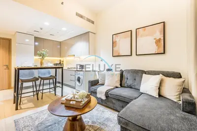 a living room with a couch and a table at Relaxing 1BR Apartment with Built-in Wardrobe & Community View in Azizi Riviera 4, Al Merkadh by Deluxe Holiday Homes in Dubai
