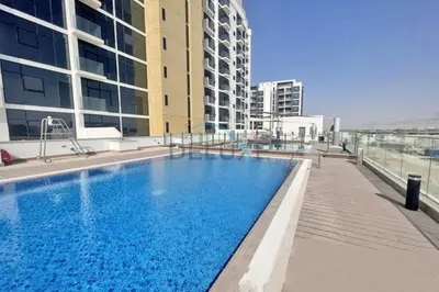 a large swimming pool on top of a building at Relaxing 1BR Apartment with Built-in Wardrobe & Community View in Azizi Riviera 4, Al Merkadh by Deluxe Holiday Homes in Dubai