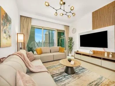 a living room with a couch and a tv at Amazing Stay Experience - Best Burj Khalifa View in Dubai