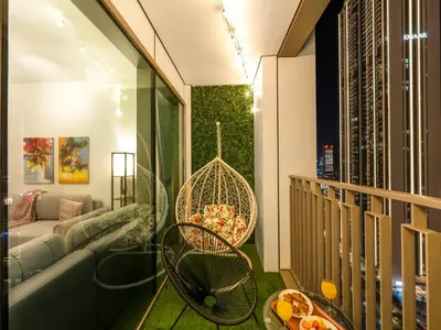 a balcony with a couch and a swing at Amazing Stay Experience - Best Burj Khalifa View in Dubai