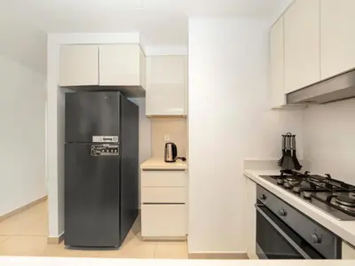 a kitchen with a black refrigerator and a stove at Amazing Stay Experience - Best Burj Khalifa View in Dubai