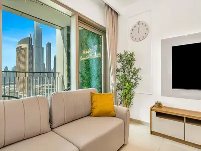 a living room with a couch and a large window at Amazing Stay Experience - Best Burj Khalifa View in Dubai