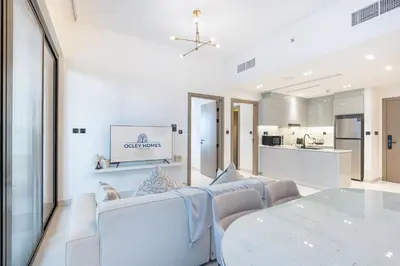 a living room with a couch and a table at Stylish Home with Direct Pool Access by the Canal in Dubai
