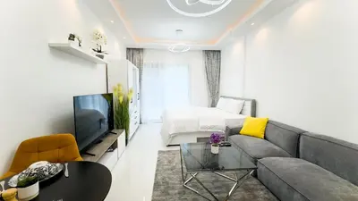 a living room with a couch and a tv at Dubai Marina - Cozy Studio Apartment in Dubai