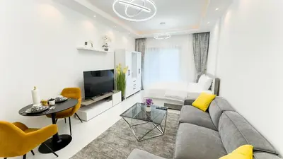 a living room with a couch and a table at Dubai Marina - Cozy Studio Apartment in Dubai