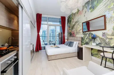 a hotel room with a bed and a window at Beautiful Stylish Apartment with Marina Views in Dubai