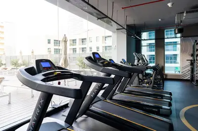 a row of treadmills in a gym at Beautiful Stylish Apartment with Marina Views in Dubai