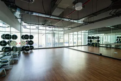 an empty gym with a wooden floor and a dance floor at Beautiful Stylish Apartment with Marina Views in Dubai