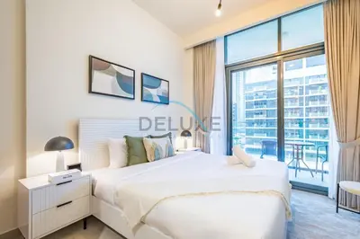 a bedroom with a large bed and a large window at Lovely Studio Apartment at Azizi Riviera 46 in Al Merkadh by Deluxe Holiday Homes in Dubai