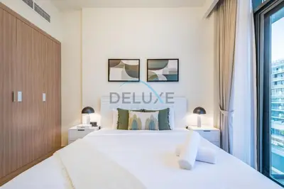 a bedroom with a large white bed and a window at Lovely Studio Apartment at Azizi Riviera 46 in Al Merkadh by Deluxe Holiday Homes in Dubai
