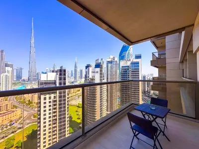 a balcony with a table and a view of the city at Prime 2BR with Burj Khalifa & Dubai Canal View - 20AB16 in Dubai