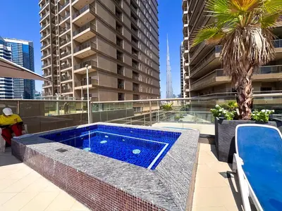 a swimming pool on the roof of a building at Prime 2BR with Burj Khalifa & Dubai Canal View - 20AB16 in Dubai