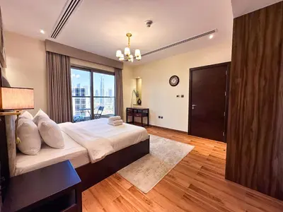 a bedroom with a large bed and a large window at Prime 2BR with Burj Khalifa & Dubai Canal View - 20AB16 in Dubai