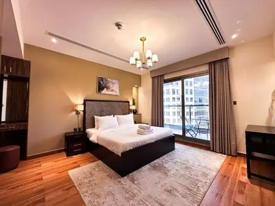 a bedroom with a bed and a large window at Prime 2BR with Burj Khalifa & Dubai Canal View - 20AB16 in Dubai