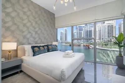 a bedroom with a large bed and a large window at AirDXB - Exceptional 3bedroom with the incredible view in Dubai Marina in Dubai