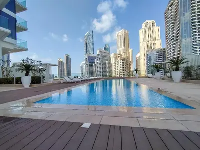 a large swimming pool in a city with tall buildings at AirDXB - Exceptional 3bedroom with the incredible view in Dubai Marina in Dubai