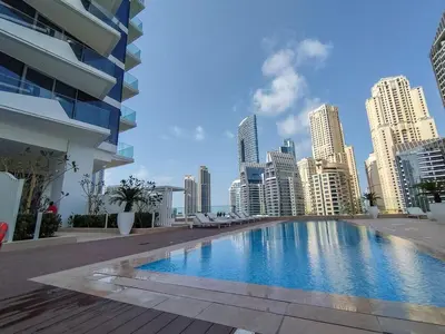 a large swimming pool in a city with tall buildings at AirDXB - Exceptional 3bedroom with the incredible view in Dubai Marina in Dubai