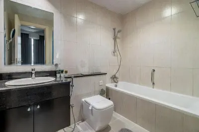 a bathroom with a sink and a toilet and a tub at Exquisite 1Bedroom With City Views in Dubai