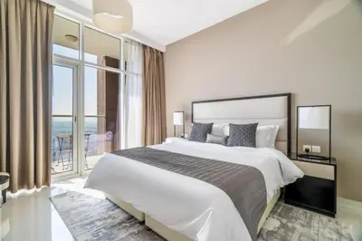a bedroom with a large bed and a large window at Exquisite 1Bedroom With City Views in Dubai