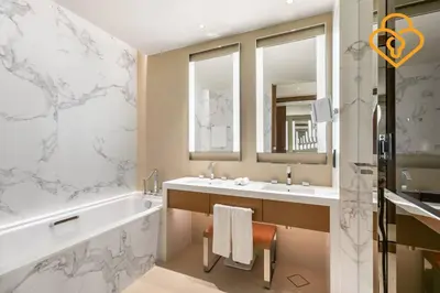 a bathroom with a tub and two sinks and a bath tub at Keysplease Address Opera 2BR Downtown 26 in Dubai