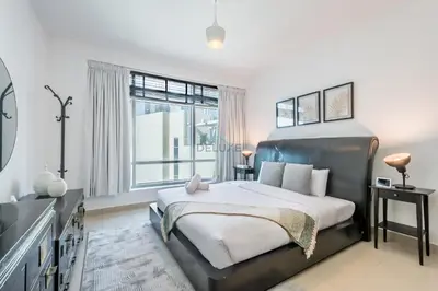 a bedroom with a large bed and a window at Elegant 2BR in Park Island Bonaire, Dubai Marina by Deluxe Holiday Homes in Dubai