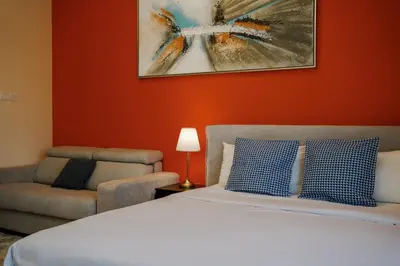 a bedroom with a bed and a chair at Cozy studio in Business Bay Dubai in Dubai