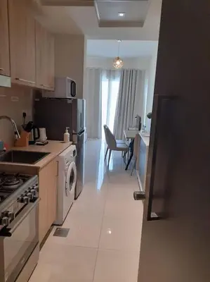 a kitchen with a sink and a stove top oven at Cozy studio in Business Bay Dubai in Dubai