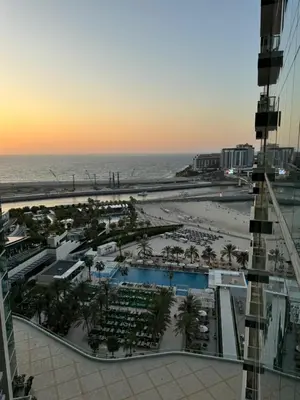 a view of the beach and the ocean from a building at Lovely 3BHK with private beach in Dubai
