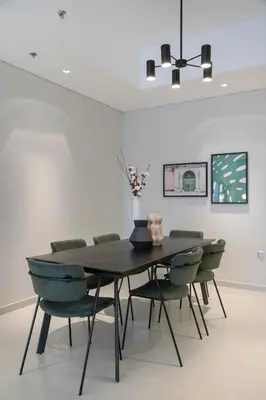 a dining room with a table and chairs at 2BR API 1000 Community View Jumeirah in Dubai