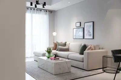 a living room with a couch and a coffee table at 2BR API 1000 Community View Jumeirah in Dubai