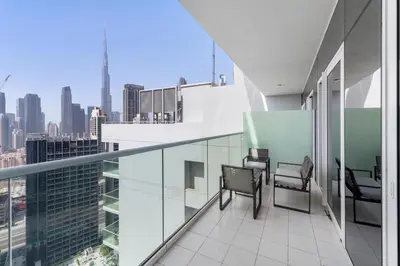 a balcony with chairs and a view of the city at Exclusive Burj Khalifa View - Modern 1 BR in Dubai