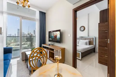 a hotel room with a bed and a table and a television at Exclusive Burj Khalifa View - Modern 1 BR in Dubai
