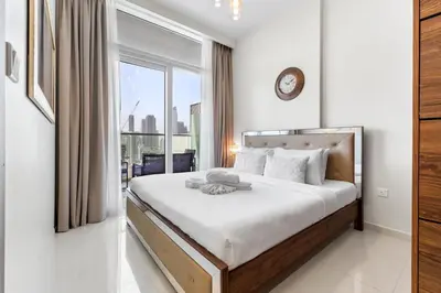 a bedroom with a large bed with a large window at Exclusive Burj Khalifa View - Modern 1 BR in Dubai