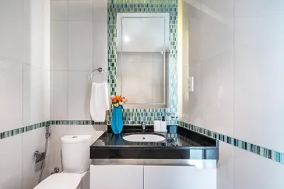 a bathroom with a sink and a toilet and a mirror at The Smart Concierge - Damac Heights in Dubai