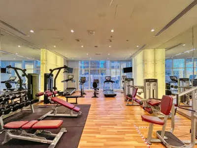 a gym with treadmills and machines in a building at The Smart Concierge - Damac Heights in Dubai