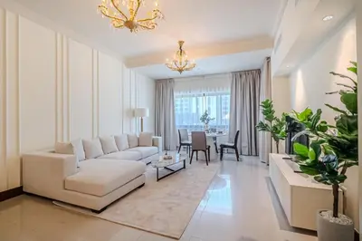 a living room with a white couch and a table at Apartment with Palm Jumeirah view I Golden Mile in Dubai