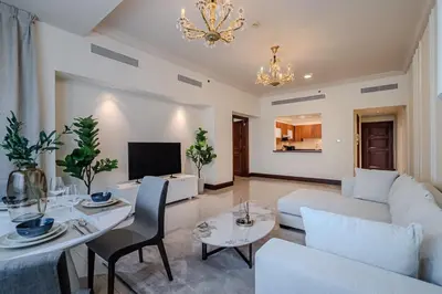 a living room with a couch and a table at Apartment with Palm Jumeirah view I Golden Mile in Dubai