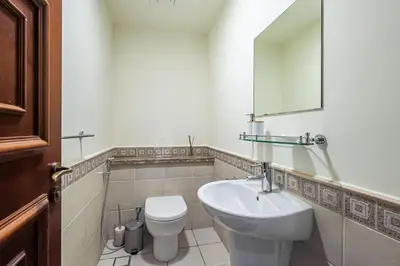 a bathroom with a sink and a toilet and a mirror at Apartment with Palm Jumeirah view I Golden Mile in Dubai