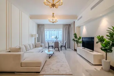 a living room with a couch and a tv at Apartment with Palm Jumeirah view I Golden Mile in Dubai