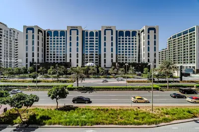 a parking lot in front of a large building at Apartment with Palm Jumeirah view I Golden Mile in Dubai