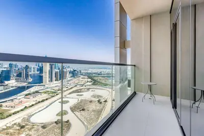an apartment balcony with a view of the city at Knokey Aykon City in Dubai