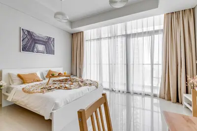 a bedroom with a bed and a large window at Knokey Aykon City in Dubai